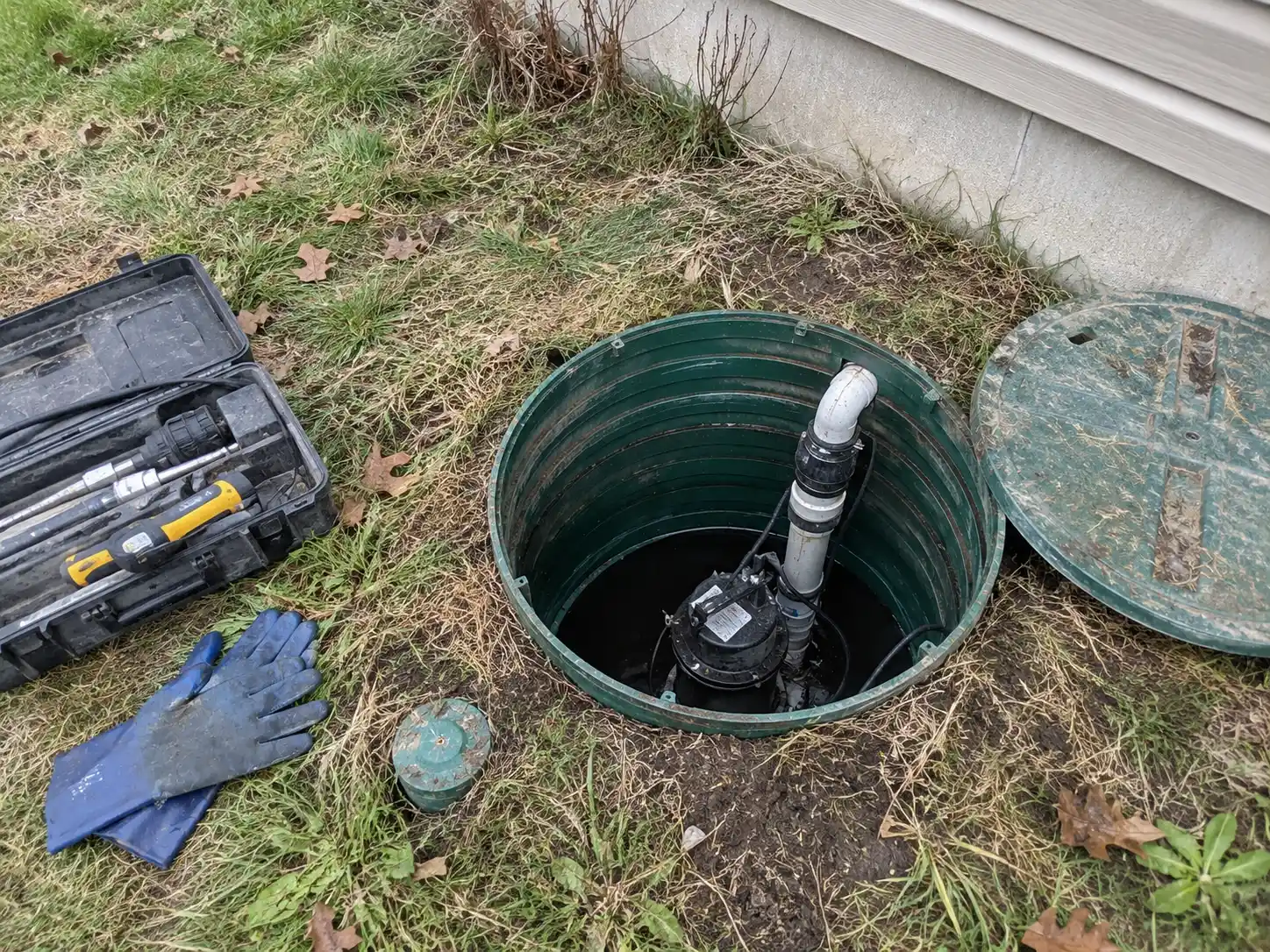 Residential septic effluent pump chamber with discharge piping and maintenance tools in New Dundee Ontario